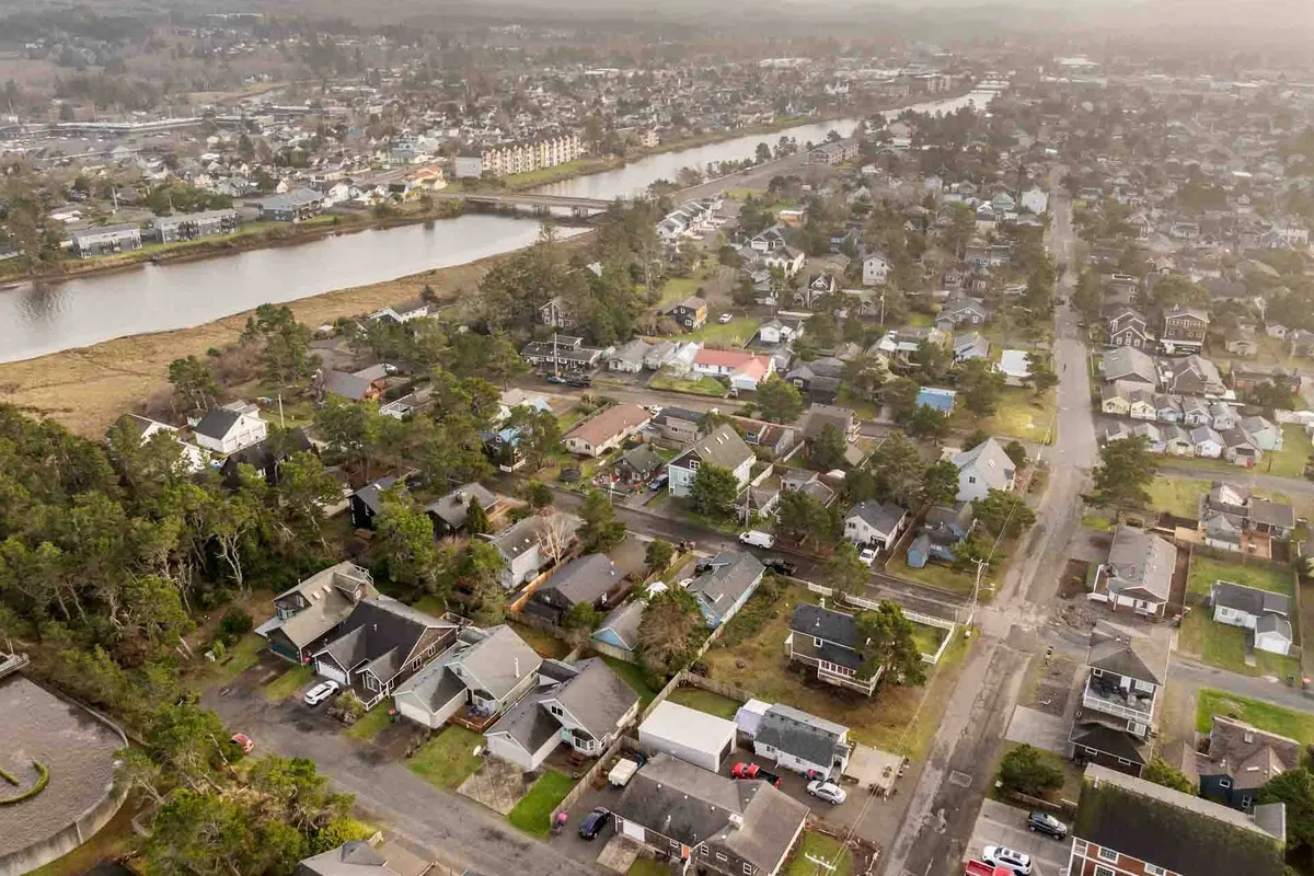 The image captures a scenic view of a winding river bordered by green spaces and residential homes, with quiet roads and walkways inviting exploration. The peaceful natural setting is complemented by the presence of nearby community parks.