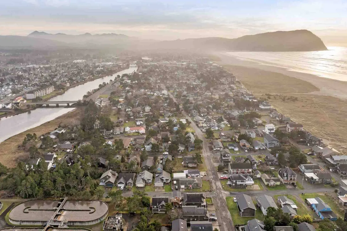 A scenic vista of a river meeting the beach, dotted with nearby houses and rolling hills. The area hints at both natural beauty and the welcoming presence of small communities—ideal for walking, boating, and discovering local artisans.